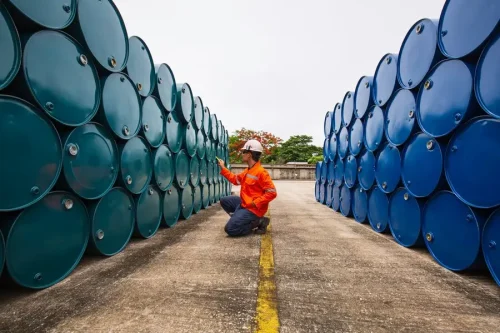 male-worker-inspection-record-drum-oil-stock-barrels-blue-green-horizontal-chemical-industry_478515-3429